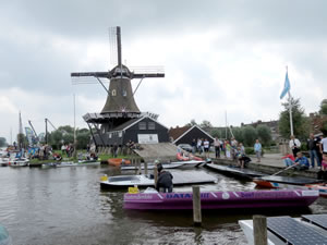 Old-style windmill overshadowing the solar boats