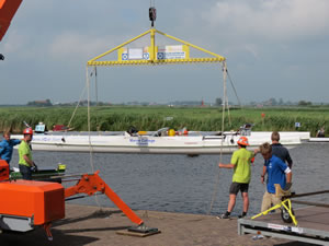 Boat being lifted from the water by a crane